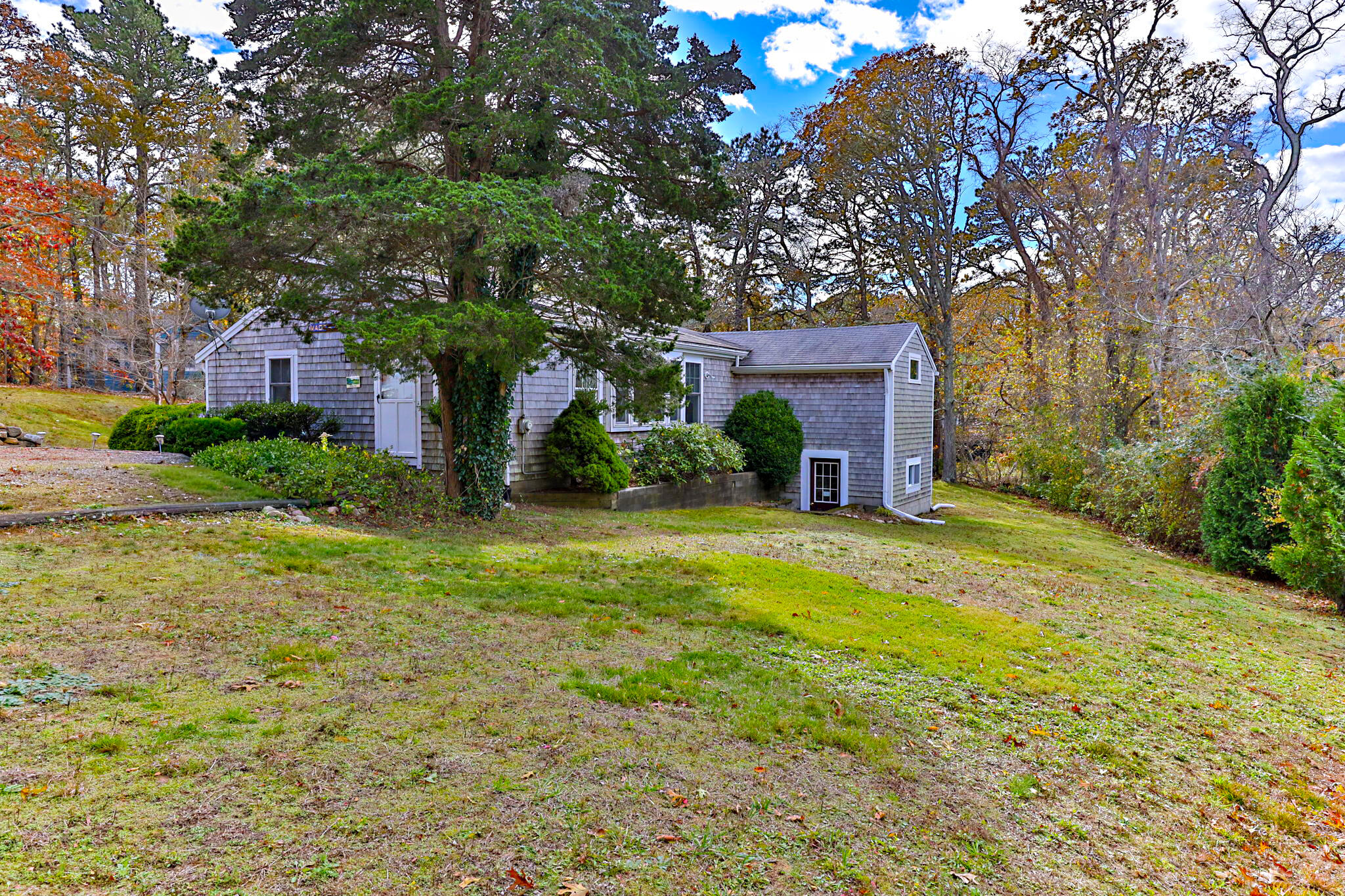 6 Cora Nickerson Road Harwich, MA 02645 - Photo 39 of 42 a yellow house in middle of the forest