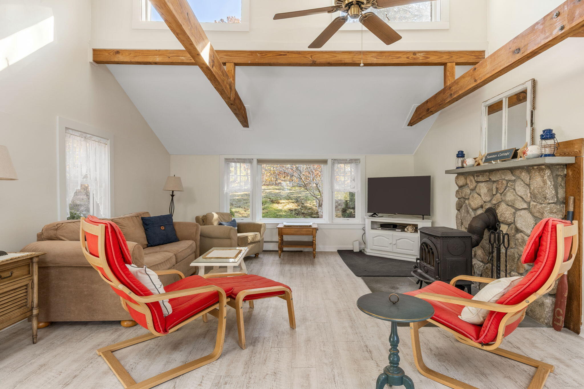 6 Cora Nickerson Road Harwich, MA 02645 - Photo 7 of 42 a living room with furniture a flat screen tv and kitchen view