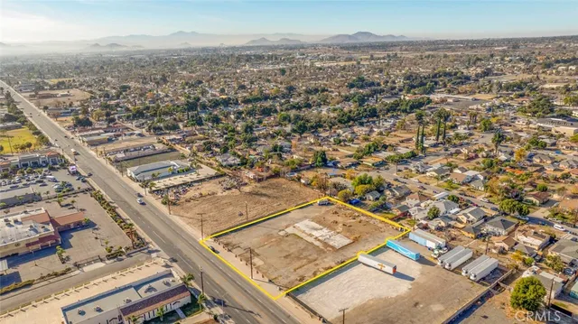 an aerial view of residential houses with outdoor space and river