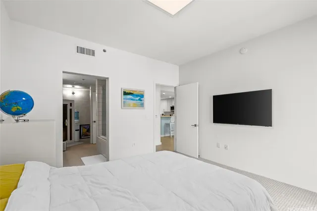 a bedroom with a bed and a flat screen tv