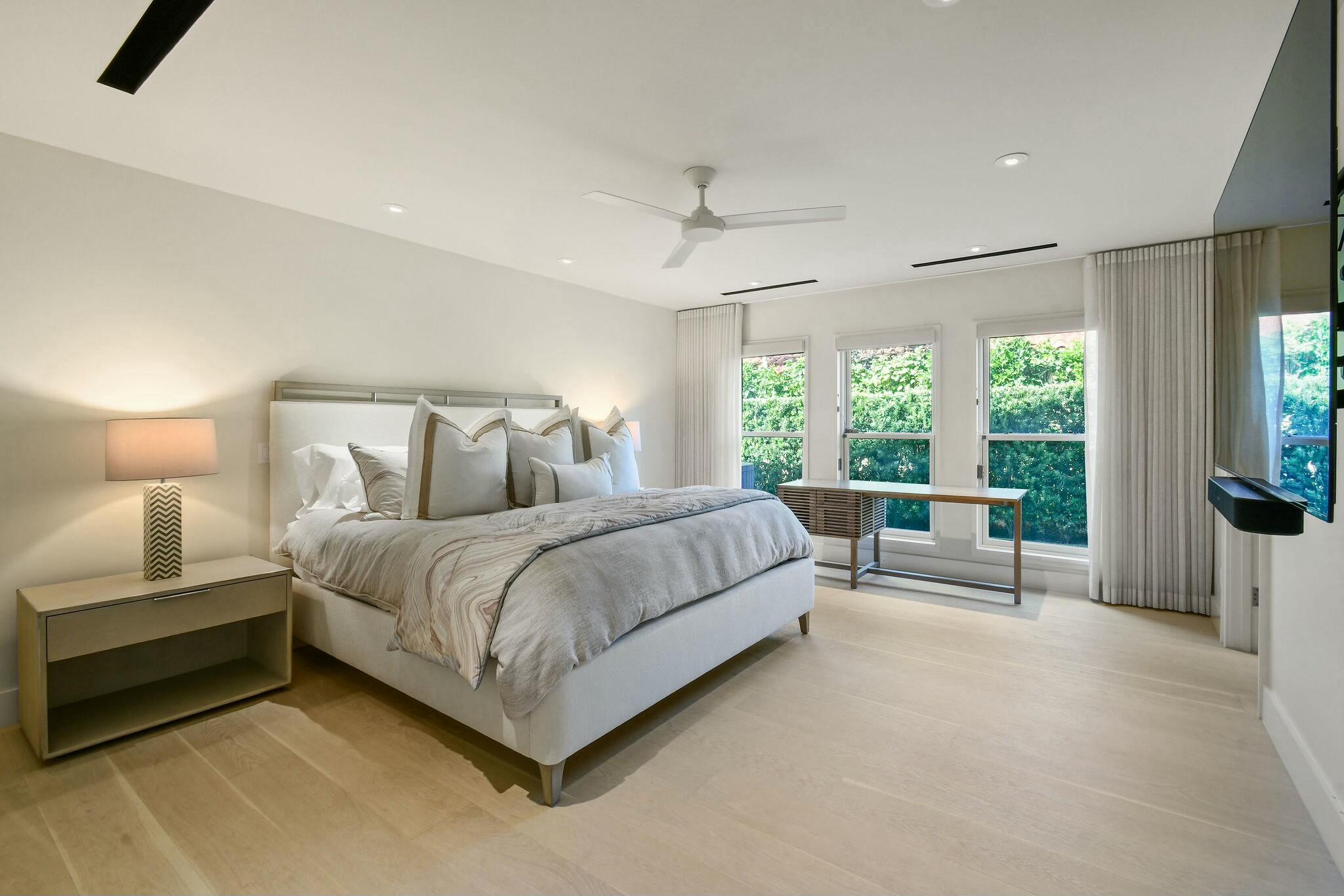 170 Beacon Lane Jupiter Inlet Colony, FL 33469 - Photo 11 of 46 a spacious bedroom with a bed and a large window