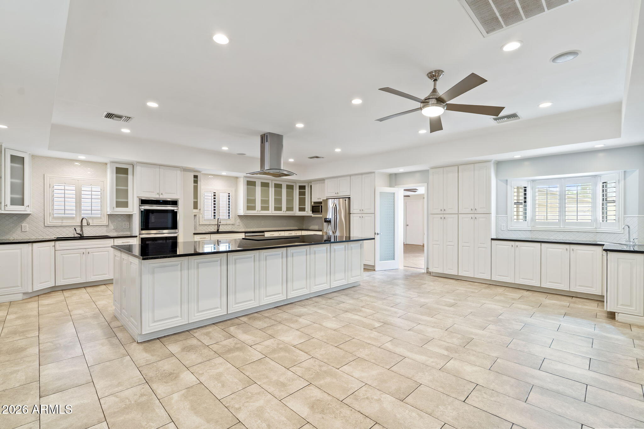 1345 East Ocotillo Road Phoenix, AZ 85014 - Photo 11 of 34 a large kitchen with kitchen island granite countertop lots of counter top and appliances