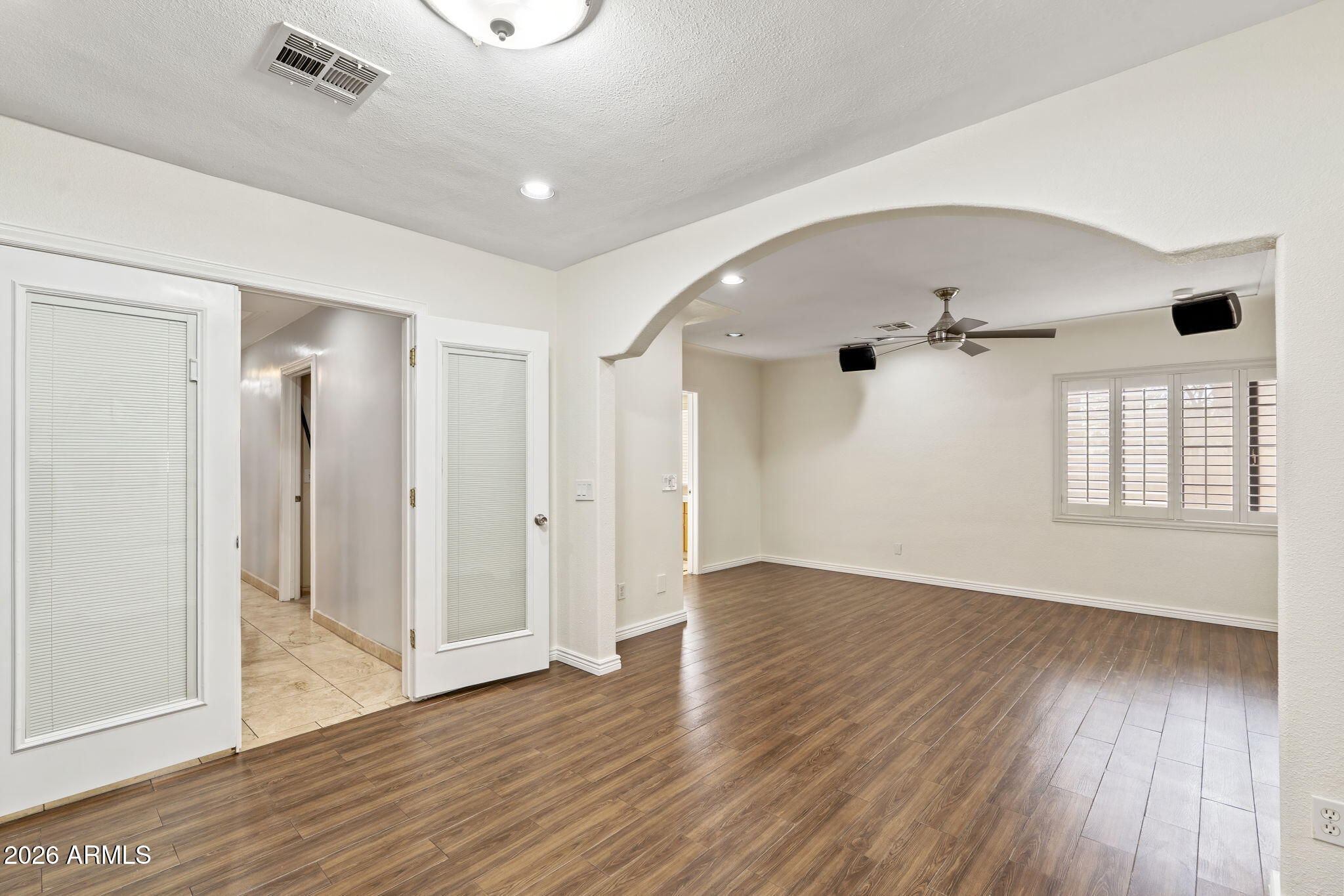 1345 East Ocotillo Road Phoenix, AZ 85014 - Photo 16 of 34 an empty room with wooden floor and windows