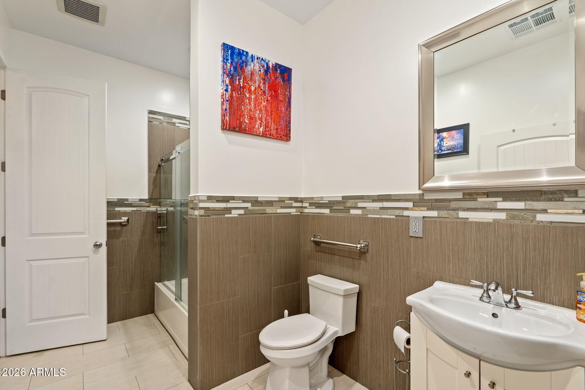 1345 East Ocotillo Road Phoenix, AZ 85014 - Photo 31 of 34 a bathroom with a toilet sink and mirror