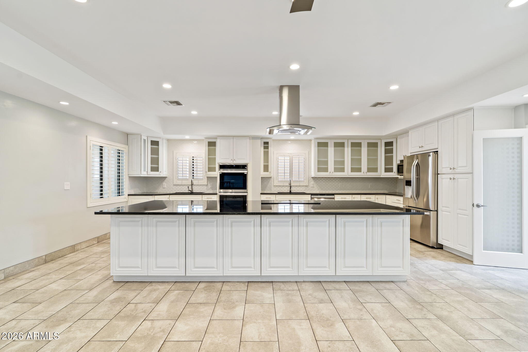 1345 East Ocotillo Road Phoenix, AZ 85014 - Photo 10 of 34 a large kitchen with granite countertop a sink and white cabinets