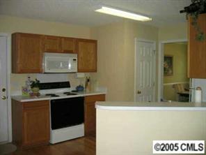 6119 Nevin Road Charlotte, NC 28262 - Photo 4 of 8 a kitchen with a sink and cabinets