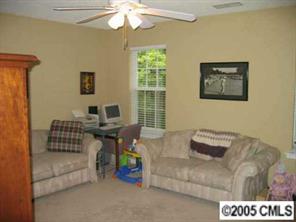 6119 Nevin Road Charlotte, NC 28262 - Photo 5 of 8 a living room with furniture and a chandelier