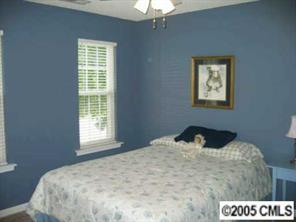 6119 Nevin Road Charlotte, NC 28262 - Photo 6 of 8 a bedroom with a bed and a window