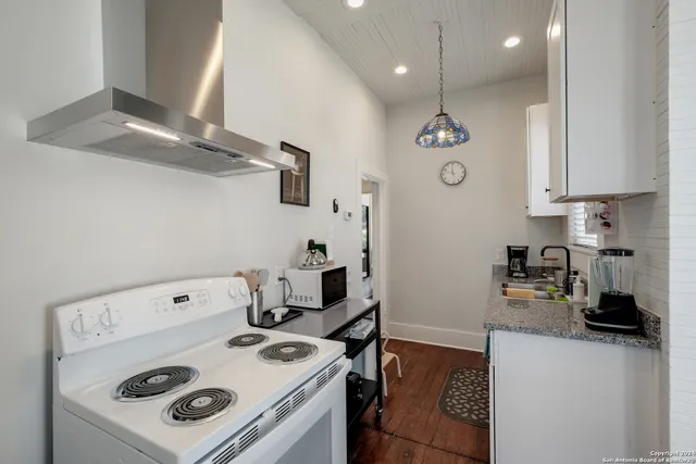 a kitchen with appliances cabinets and a counter top space