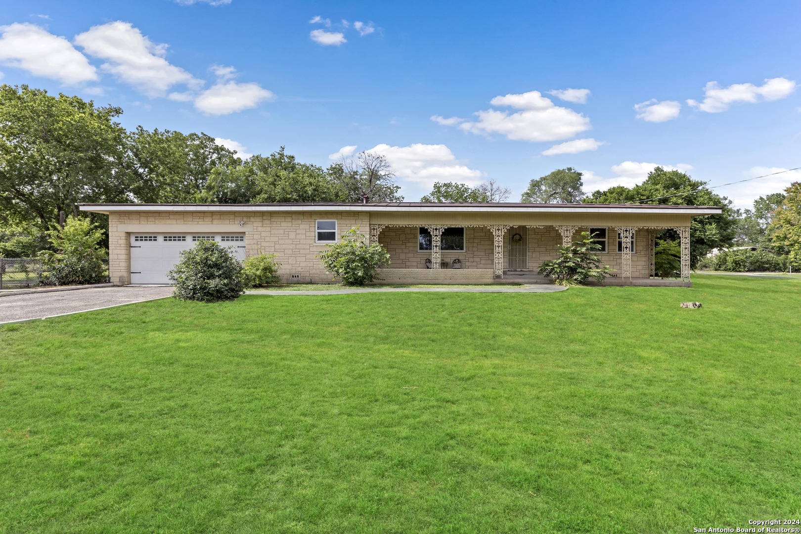 a front view of house with yard and green space