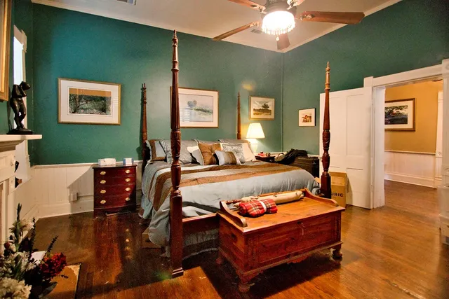 a bedroom with furniture and wooden floor