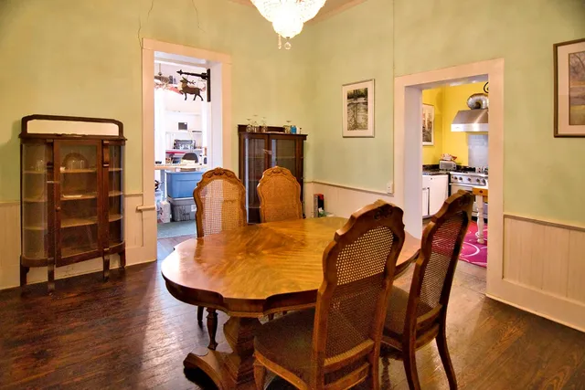 a dining room with furniture and wooden floor