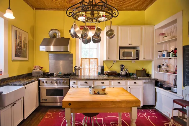 a kitchen with a sink a stove and cabinets