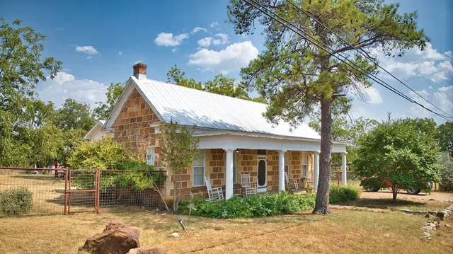 a view of a house with backyard and sitting area