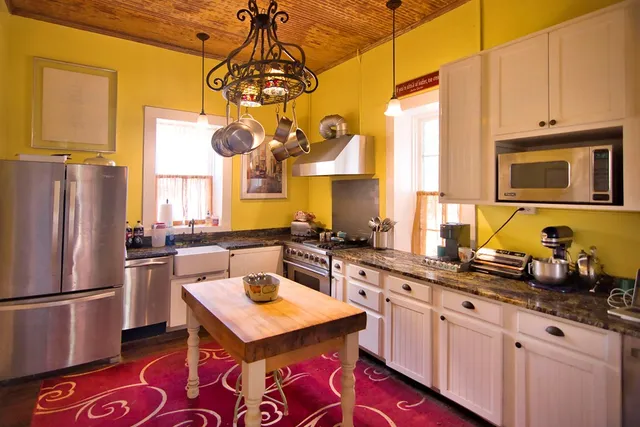 a kitchen with stainless steel appliances granite countertop a sink a stove and refrigerator