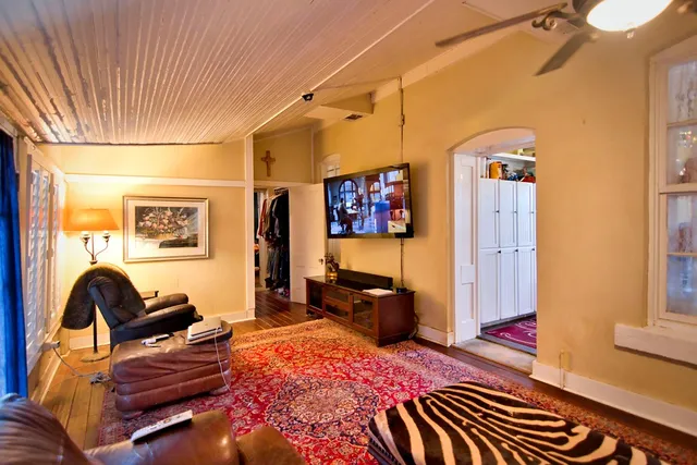 a bedroom with furniture and wooden floor