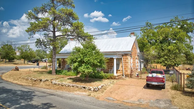a wooden bench sitting in front of a building