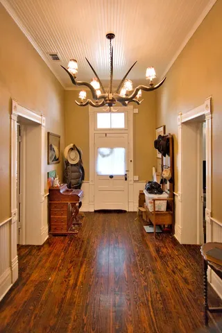 a view of a livingroom with furniture a ceiling fan and window