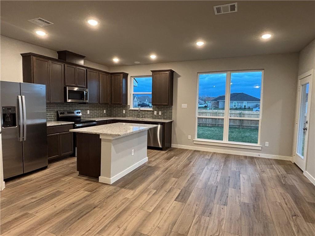 4229 Centerfire Road Waco, TX 76705 - Photo 3 of 14 a kitchen with stainless steel appliances granite countertop a stove a sink and a refrigerator