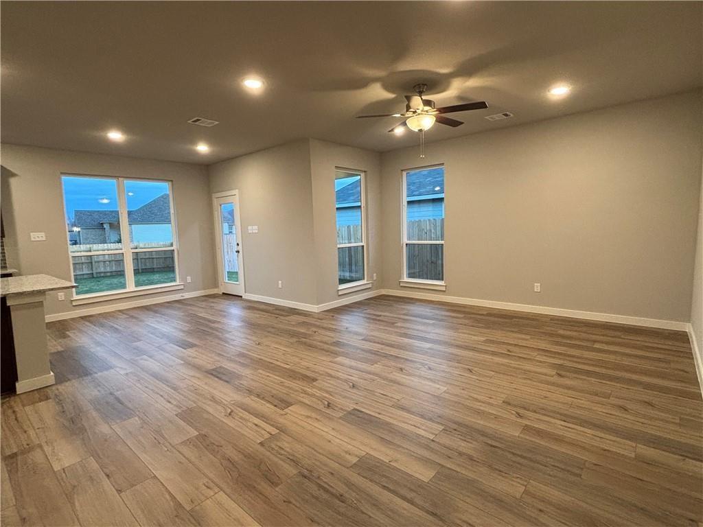 4229 Centerfire Road Waco, TX 76705 - Photo 5 of 14 a view of an empty room with wooden floor and a window