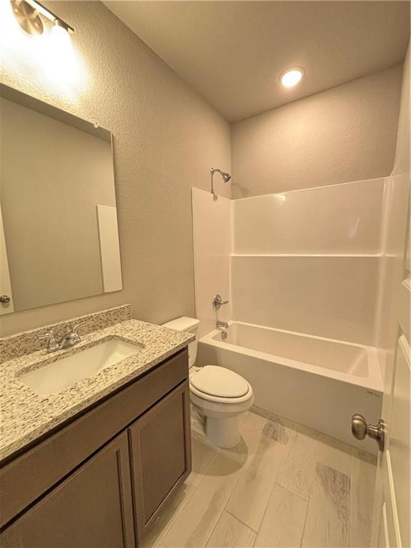 4229 Centerfire Road Waco, TX 76705 - Photo 10 of 14 a bathroom with a granite countertop sink a toilet and bathtub