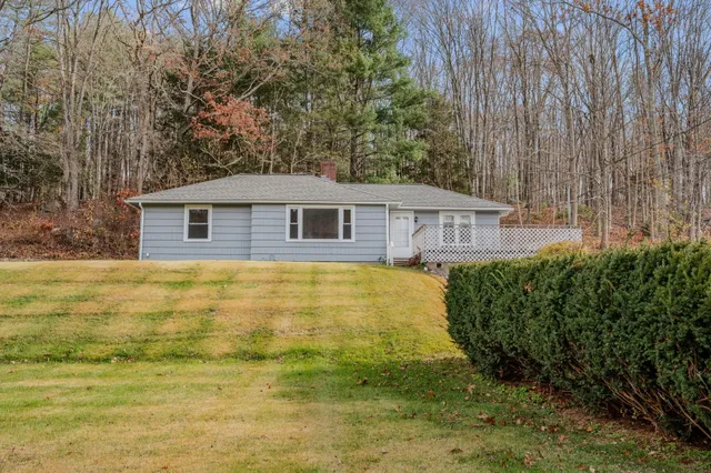 a view of a house with a backyard