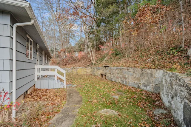 a kitchen with stainless steel appliances kitchen island granite countertop a refrigerator and a stove top oven