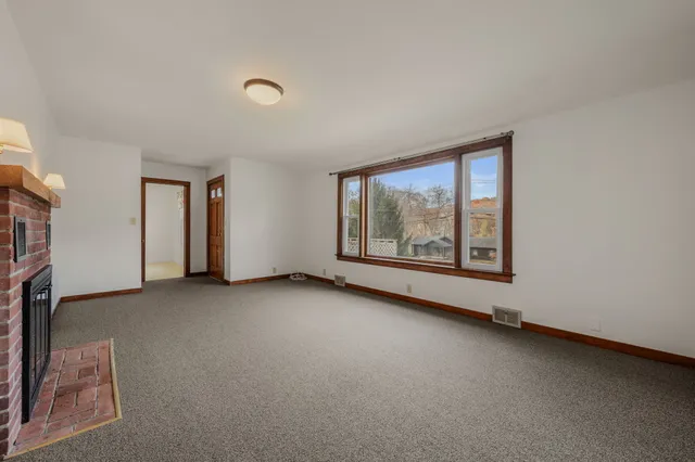 an empty room with wooden floor and closet