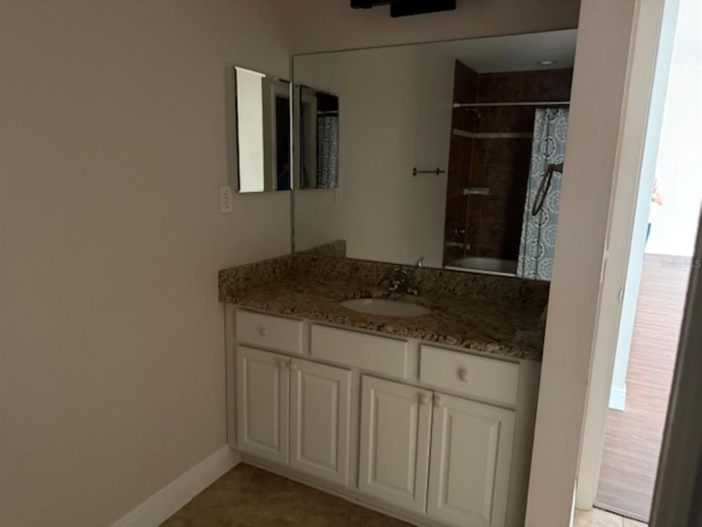 3707 Southeast 24th Street Ocala, FL 34471 - Photo 11 of 14 a bathroom with a granite countertop sink and a mirror