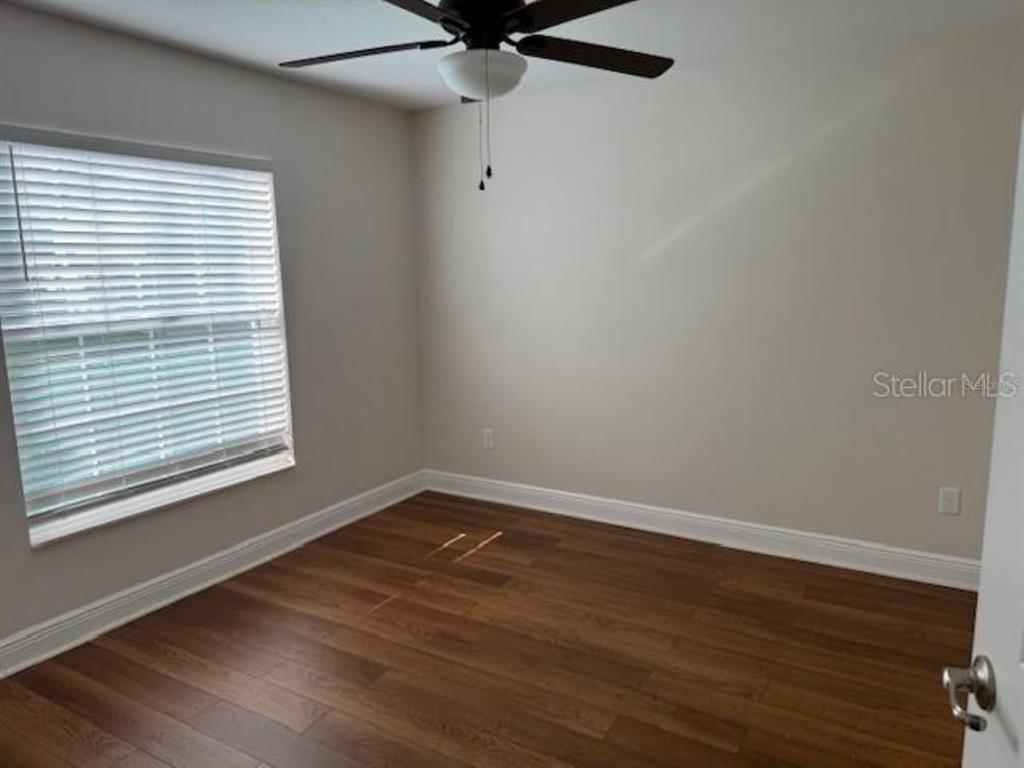 3707 Southeast 24th Street Ocala, FL 34471 - Photo 12 of 14 wooden floor in an empty room with a window