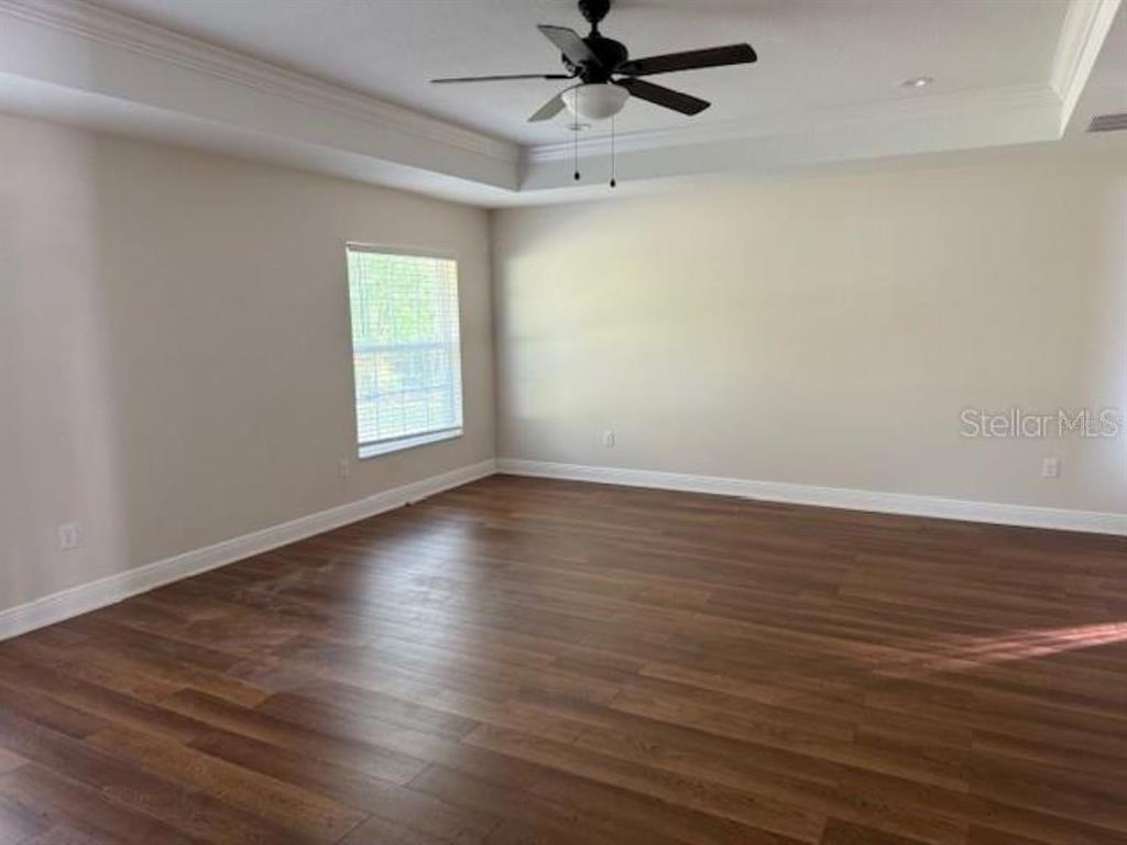 3707 Southeast 24th Street Ocala, FL 34471 - Photo 6 of 14 an empty room with wooden floor fan and windows