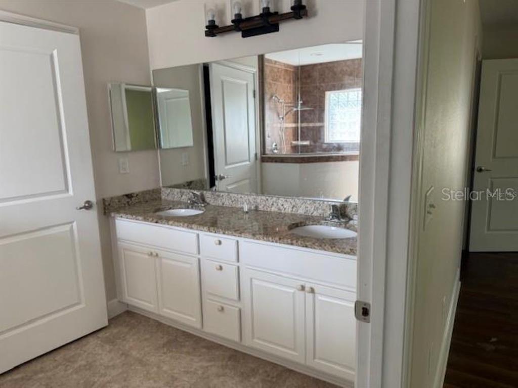 3707 Southeast 24th Street Ocala, FL 34471 - Photo 7 of 14 a bathroom with a granite countertop sink and a mirror