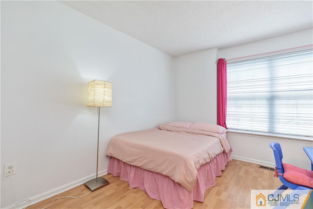110 Prestwick Way Edison, NJ 08820 - Photo 15 of 26 a bedroom with a bed and a table