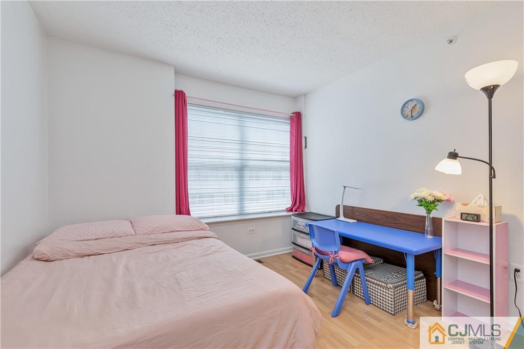 110 Prestwick Way Edison, NJ 08820 - Photo 16 of 26 a bedroom with a bed and a table