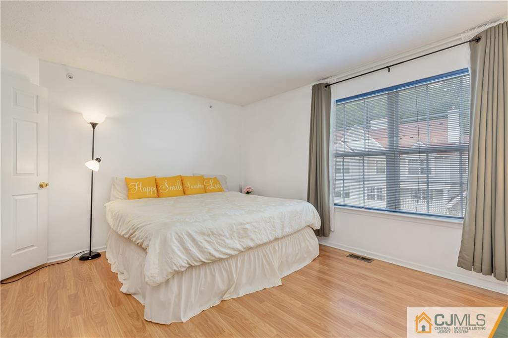 110 Prestwick Way Edison, NJ 08820 - Photo 18 of 26 a bedroom with a large bed and a large window