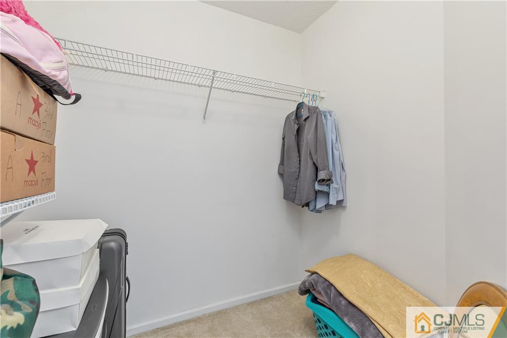 110 Prestwick Way Edison, NJ 08820 - Photo 19 of 26 a view of walk in closet with clothes and shoes