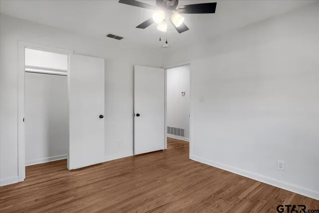 a view of an empty room and wooden floor