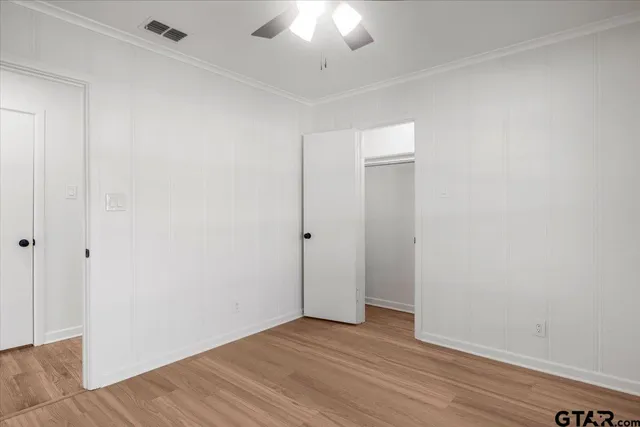 a view of an empty room with wooden floor