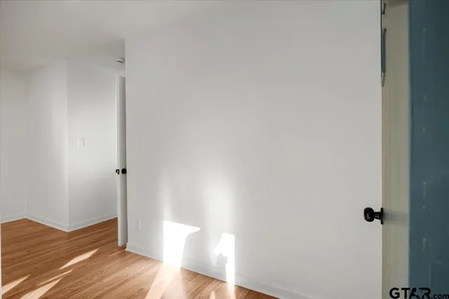 a view of a room with wooden floor