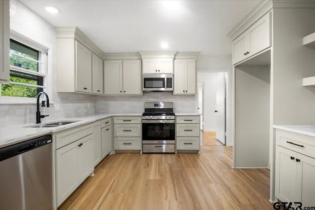 a kitchen with a white stove top oven and refrigerator