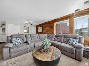 407 South Vasels Road, Unit 49 Brian Head, UT 84719 - Photo 7 of 40 Living room featuring wooden walls and ceiling fan