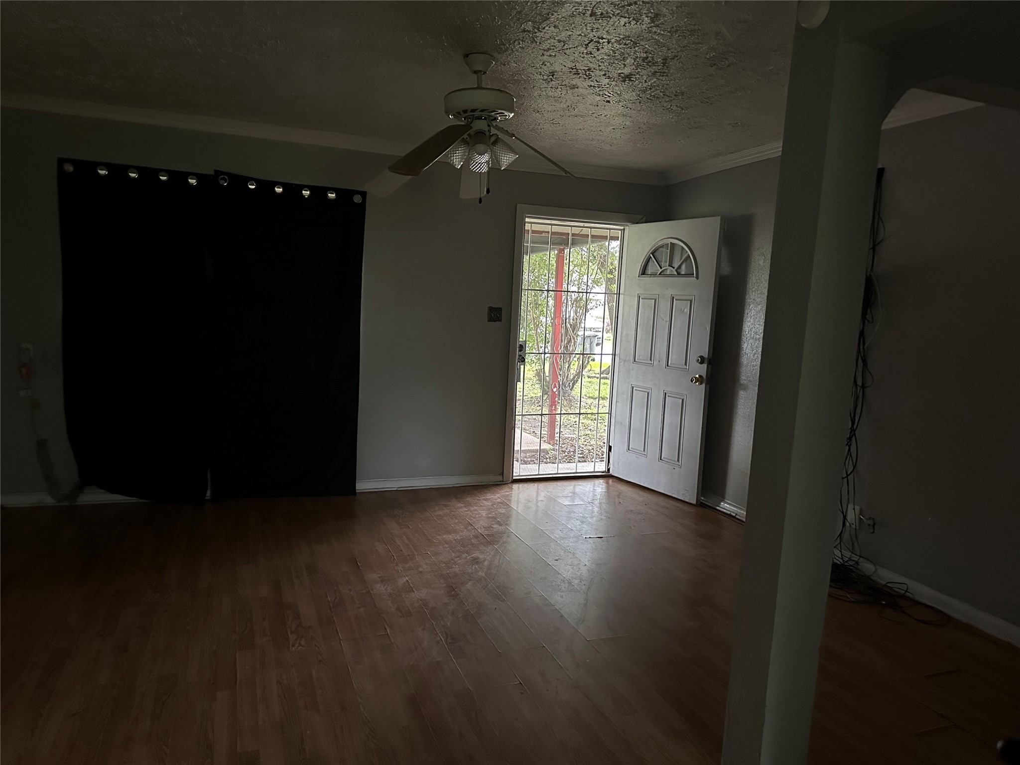 4730 Angleton Street Houston, TX 77033 - Photo 12 of 16 Spacious and inviting, the family room offers an open layout that seamlessly connects to the kitchen, creating the perfect space for both relaxing and entertaining. Abundant natural light pours in through large windows, highlighting the room's warmth and making it the heart of the home