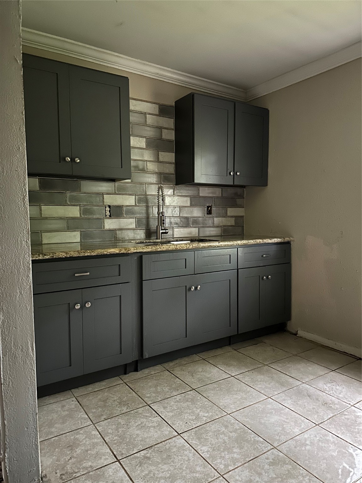 4730 Angleton Street Houston, TX 77033 - Photo 2 of 16 kitchen featuring new cabinets that offer both style and ample storage. The sleek, updated tile flooring adds a clean and contemporary touch, making this space as functional as it is inviting — perfect for everyday living or entertaining.
