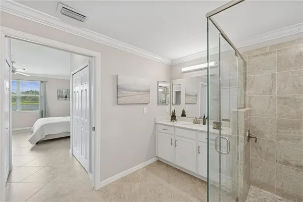 a en suite bathroom with a sink a mirror and a shower