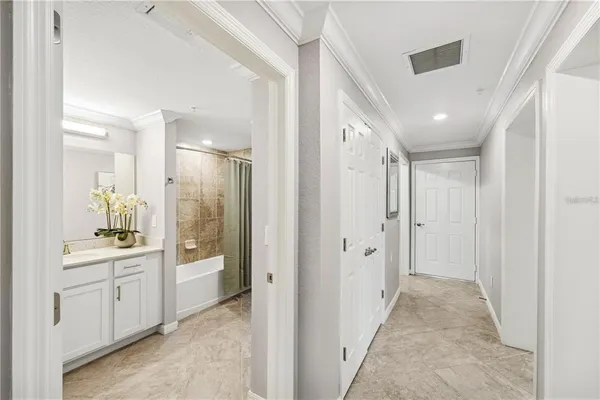 a bathroom with a glass door shower a sink and a mirror