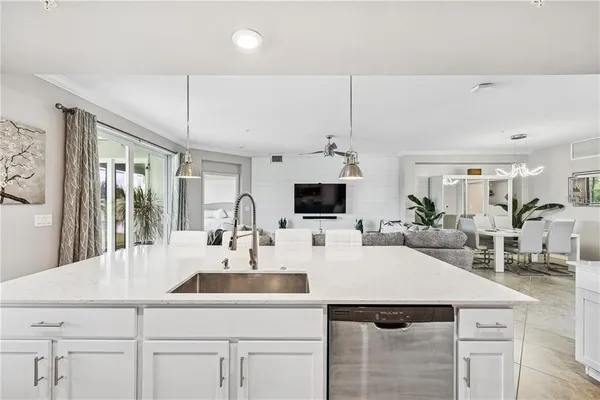 a kitchen with a sink a table and chairs