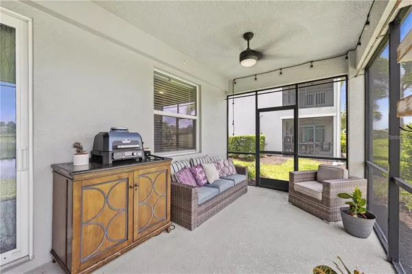 a bedroom with furniture and large windows