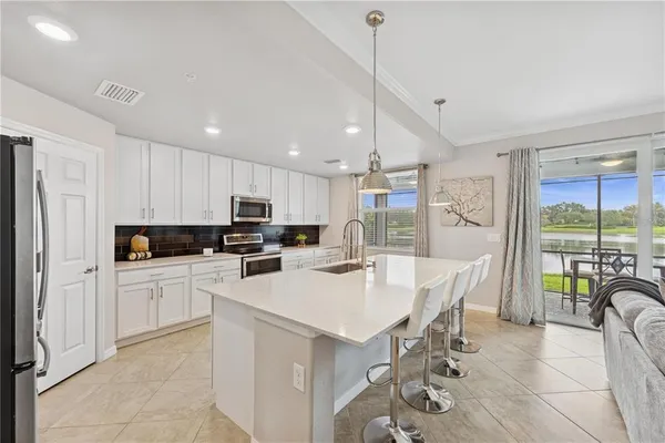 a kitchen with a table chairs refrigerator and microwave