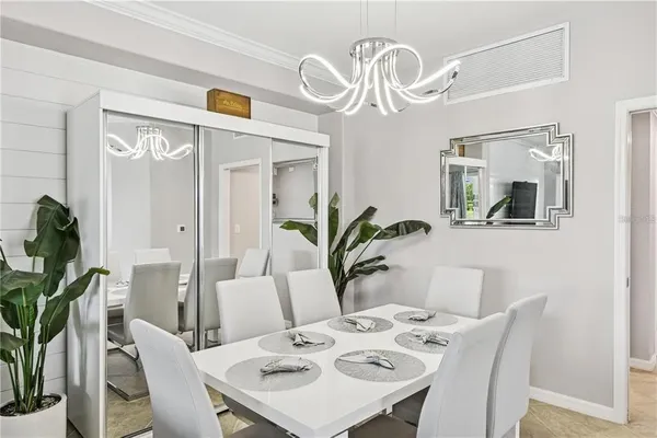 a view of a dining room with furniture a chandelier and wooden floor
