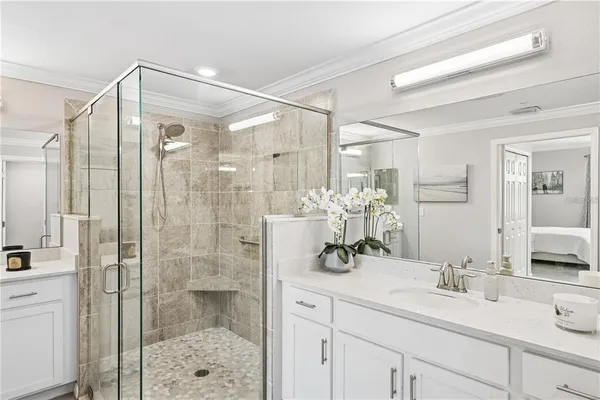 a bathroom with a shower sink and mirror